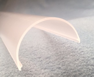 a co-extruded plastic fluorescent light lens cover in a long, half circle shape